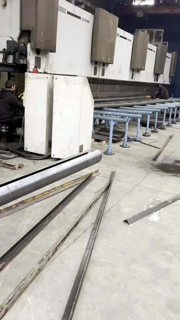 Press brake line at Artay Lighting's steel fabrication shop in Istanbul, with operators forming pole shafts